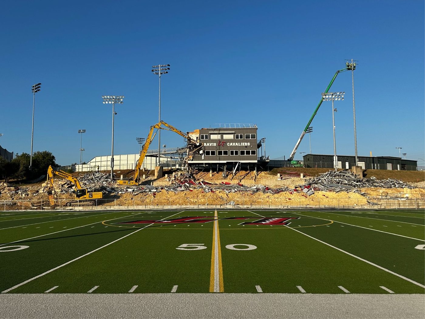 Excavators demolishing the press box at Lake Travis High School's football stadium