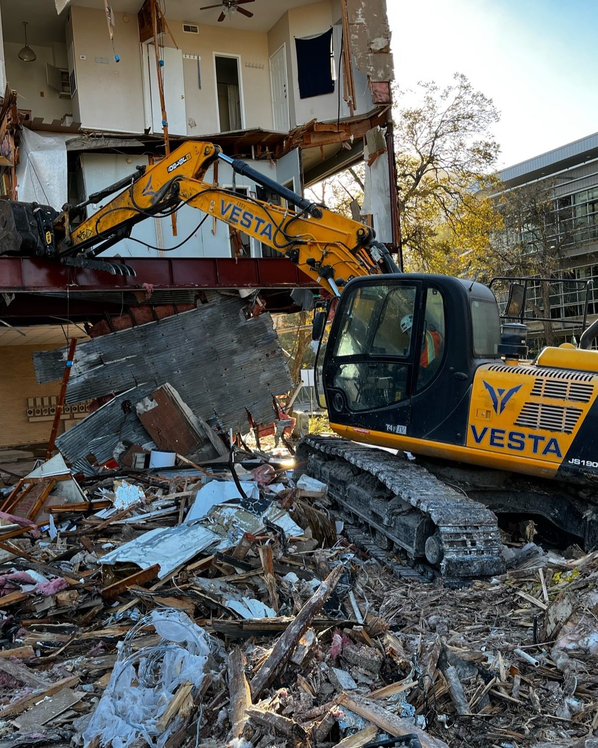 Vesta Commercial demolition excavator on an active job site