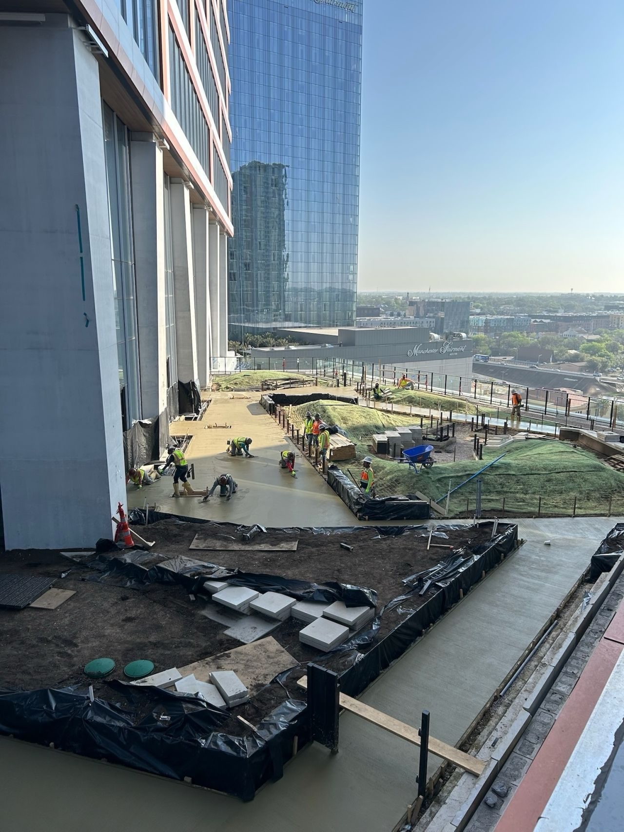 Concrete finishing work on a high-rise rooftop terrace in downtown Austin